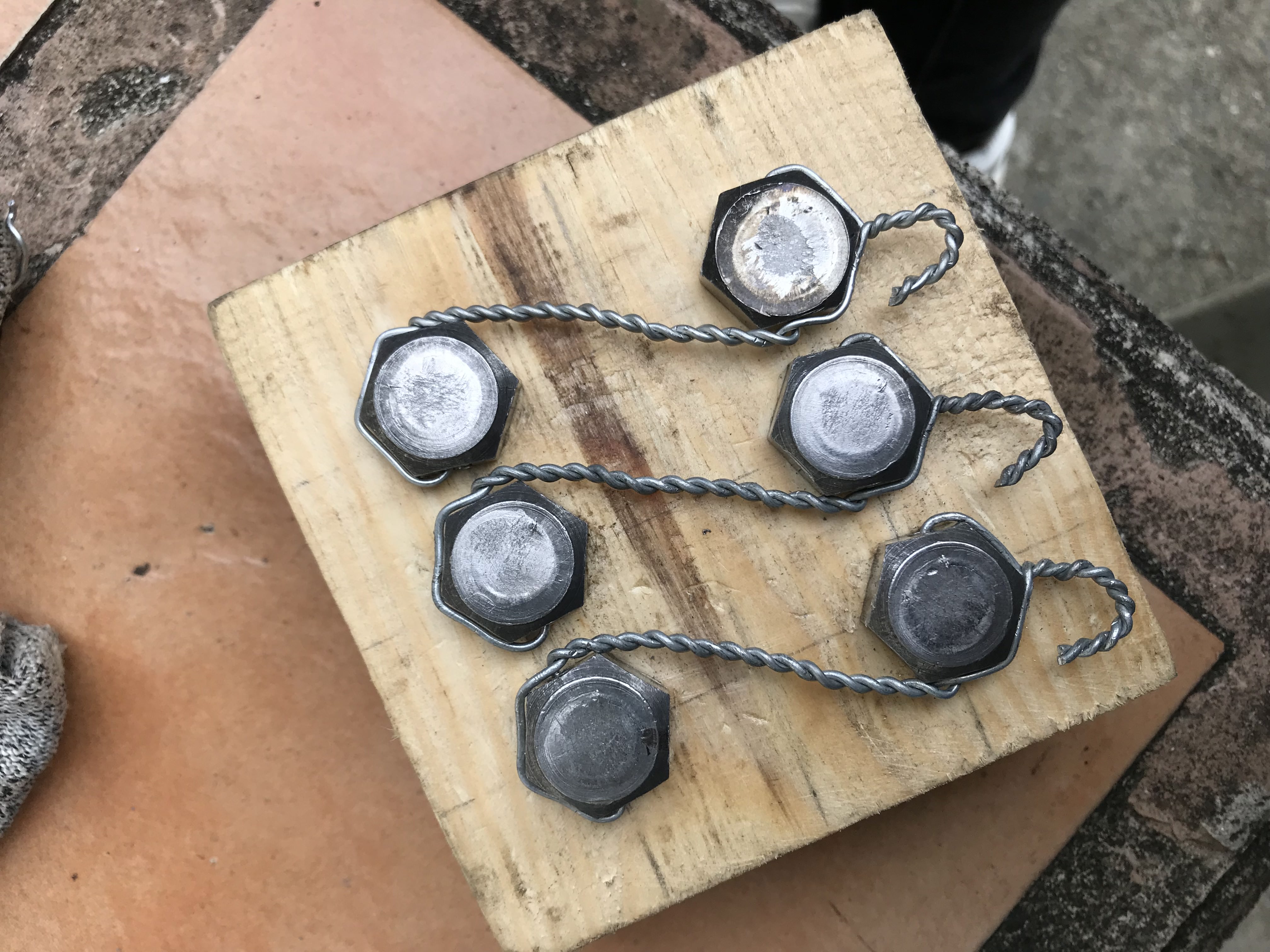 Hex plugs safety-wired in pairs on a wooden practice block